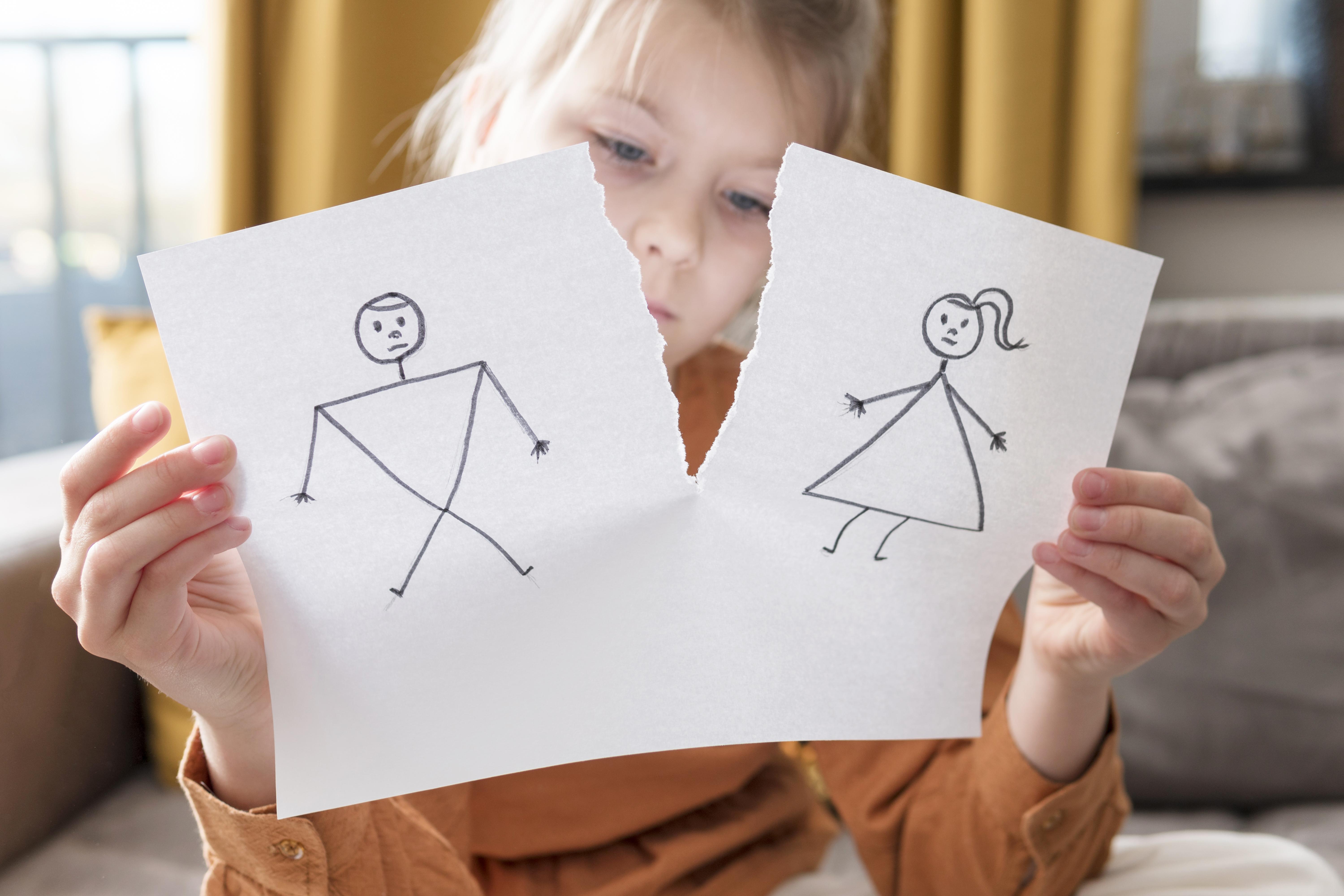 medium-shot-girl-holding-broken-drawing